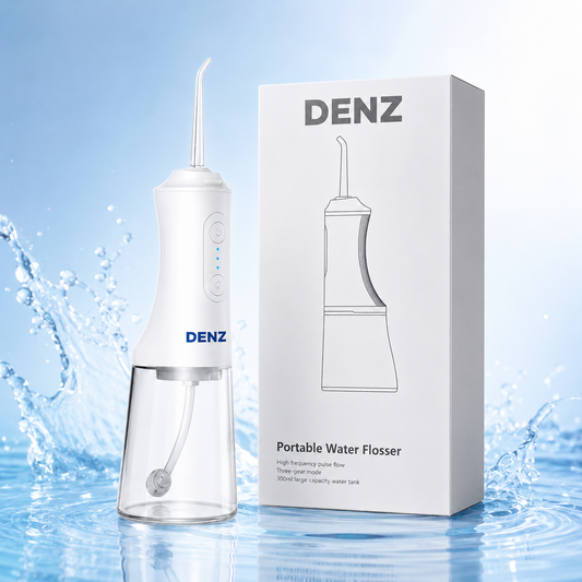 A white and clear portable water flosser shown next to its white retail box, with a blue water-splash background. The product and packaging both display the brand name DENZ.